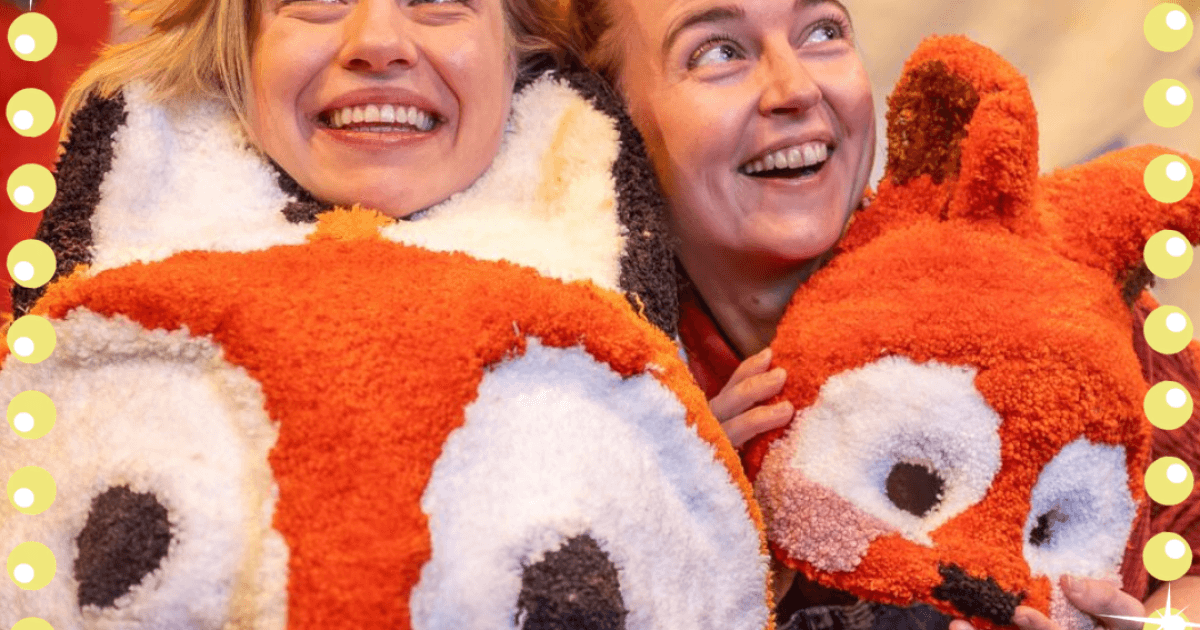Twee lachende speelsters met pluchen dierenmaskers van de Maskermeiden
